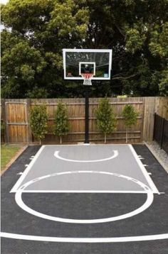 an outdoor basketball court in the backyard