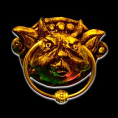 a gold ring with a dog's head on it and two eyes in the middle