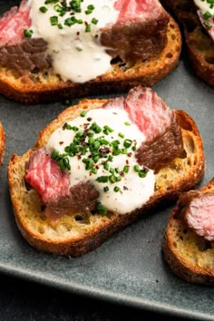 several pieces of bread topped with meat and sour cream