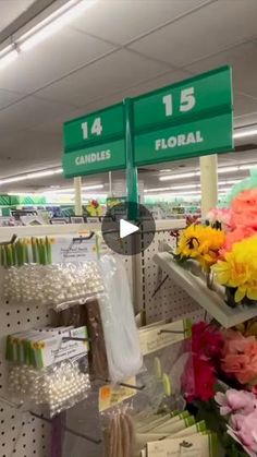 flowers are on display in a store with signs above them that read, flower 15 candles floral