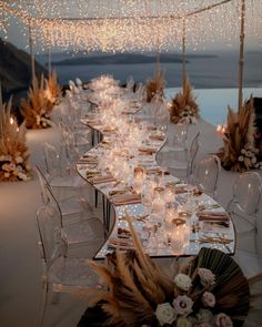 a long table is set up with candles and flowers for an elegant dinner or reception