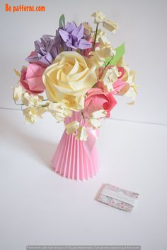 a bouquet of paper flowers sitting on top of a table