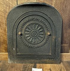 an old fashioned cast iron fire place with a magazine on the floor next to it