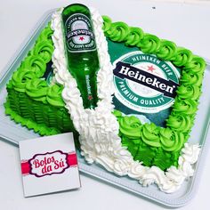 there is a cake that looks like heinekenn beer on it and a sticker next to it