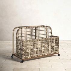 a basket sitting on top of a metal frame in the middle of a tiled floor