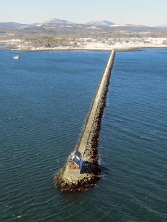 an aerial view of a long pier in the water