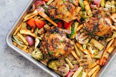 a pan filled with pasta and vegetables on top of a table