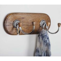 a coat rack with two coats hanging from it