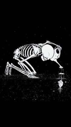 a skeleton is kneeling down in the dark