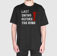 a man wearing a black t - shirt that says, last swing before the ring