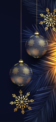 two christmas ornaments hanging from a palm tree with gold snowflakes on the branches