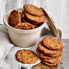 a bowl filled with cookies next to a stack of cookies