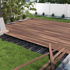 a wooden deck surrounded by grass and trees