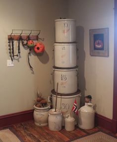 a stack of buckets sitting on top of each other in front of a wall