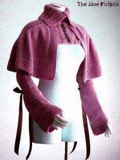 a mannequin wearing a pink knitted sweater with sleeves and buttons on it