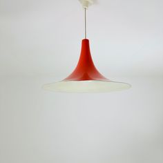 a red and white light hanging from a ceiling