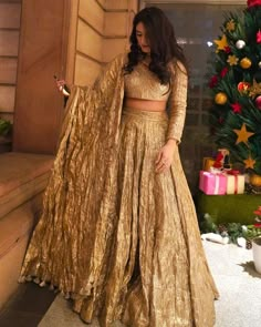 Gold Floor-length Pre-draped Saree With Cutdana, Floor-length Pre-draped Saree With Gota Work For Wedding, Gold Pre-draped Saree With Gota Work For Wedding, Fitted Gold Pre-draped Saree For Festive Occasions, Floor-length Raw Silk Sharara For Reception, Tissue Silk Lehenga With Cutdana For Reception, Gold Pre-draped Saree For Navratri Party, Reception Lehenga In Tissue Silk With Cutdana, Tissue Silk Choli For Reception And Navratri