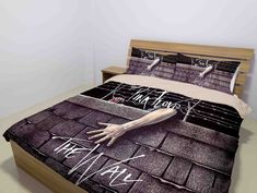 a bed with an image of a hand coming out of the roof and writing on it