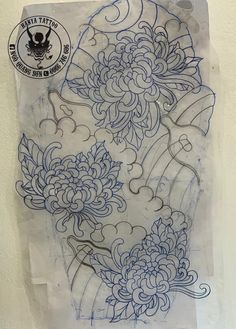 a piece of paper with blue ink on it that has an image of flowers in the middle