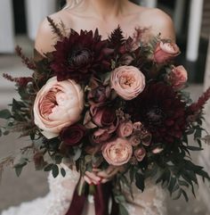 a woman holding a bouquet of flowers in her hands