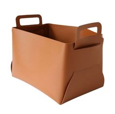 a brown leather storage bin with handles on an isolated white background for product display purposes