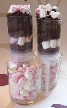 two clear cups filled with marshmallows and chocolate