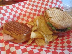 a waffle sandwich and chips on a checkered paper