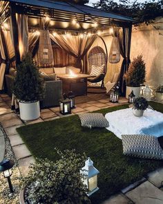 an outdoor living area is lit up with string lights