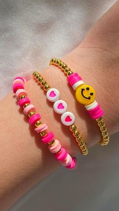 three bracelets with smiley faces on them