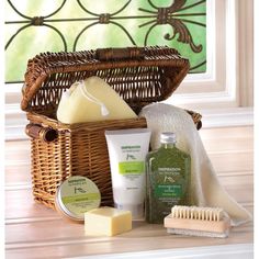 a wicker basket filled with personal care items on top of a wooden table next to a window