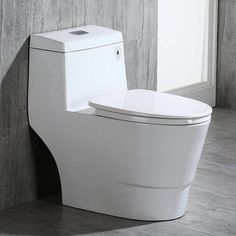 a white toilet sitting in a bathroom next to a window with the lid open and seat up