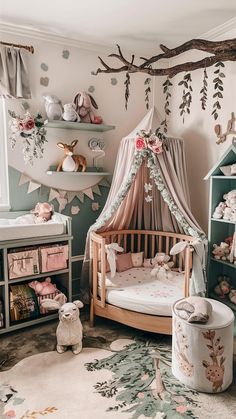 a baby's room with a canopy bed and stuffed animals on the wall,