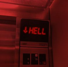 a red light that is on top of a metal machine with the word hell lit up