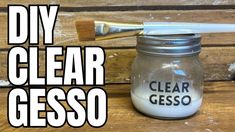 a glass jar with a paint brush in it and the words, diy clear gesso