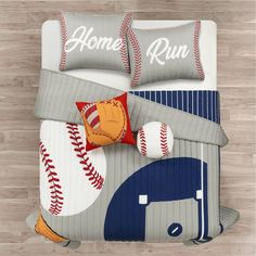 a baseball themed comforter set with two pillows and pillow cases on top of it