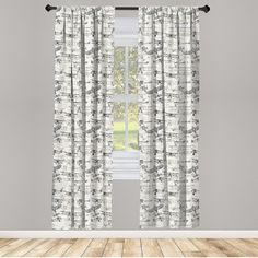 the curtains are hanging in front of a window with wood flooring and gray walls