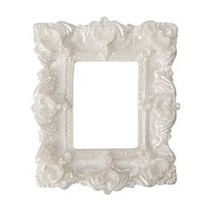 an ornate white frame with flowers on the edges and a small square hole in the middle