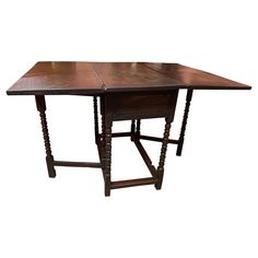 an old wooden table with two legs and a square top on the bottom, sitting against a white background