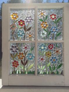 a stained glass window with flowers on it