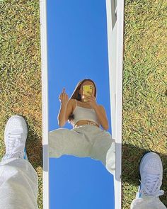 a person standing in front of a mirror with their feet on the ground next to them