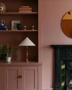 a living room filled with furniture and a fire place next to a wall mounted mirror