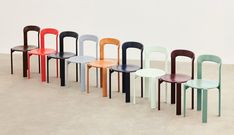 a row of different colored chairs sitting next to each other