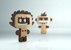 two wooden toy figurines are standing next to each other on a white surface