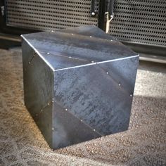 a metal box sitting on top of a carpet