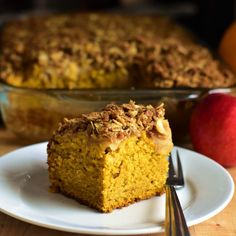 a piece of cake sitting on top of a white plate next to an apple pie