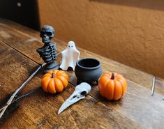 halloween decorations are sitting on a table with scissors and pumpkins next to them,