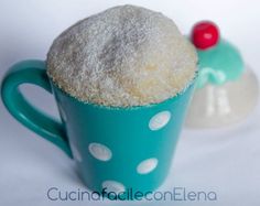 a cup filled with sugar sitting on top of a white table next to a red object