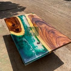 a wooden table sitting on top of a dirt road