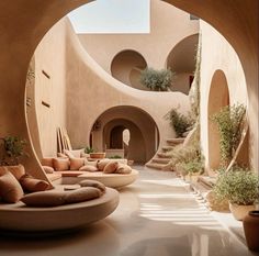 an outdoor area with couches and potted plants