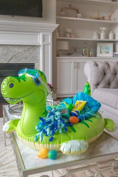 an inflatable dinosaur is sitting on a coffee table